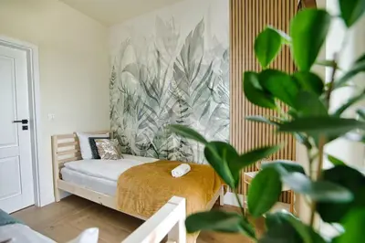 a small bedroom with a bed and a plant at Azyl by Housine in Zator