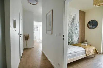 a bedroom with a door leading into a bedroom with a bed at Azyl by Housine in Zator