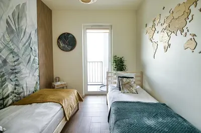 two beds in a room with a world map on the wall at Azyl by Housine in Zator