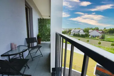 a balcony with a table and chairs and a view at Azyl by Housine in Zator