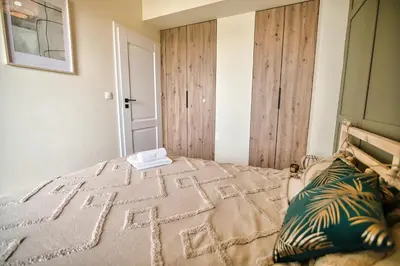 a bedroom with a bed with a wooden door at Azyl by Housine in Zator