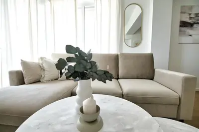 a living room with a vase on a table at Azyl by Housine in Zator