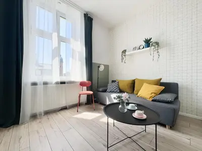 a living room with a couch and a table at GREEN APARTMENTS #Kazimierz, building A in Kraków