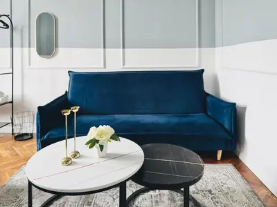 a living room with a blue couch and a coffee table at GREEN APARTMENTS #Kazimierz, building A in Kraków