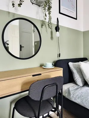 a desk with a chair and a mirror next to a bed at GREEN APARTMENTS #Kazimierz, building A in Kraków