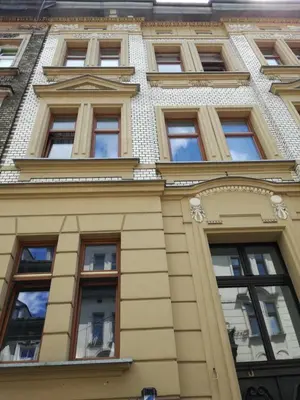 a building with many windows on the side of it at Apartament Berka 9 in Kraków