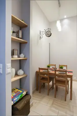 a dining room with a table and chairs at Apartament Berka 9 in Kraków
