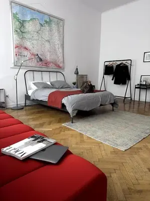 a bedroom with a bed and a map on the wall at In the heart of old town in Kraków