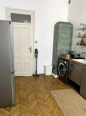 a kitchen with a refrigerator and a washing machine at In the heart of old town in Kraków