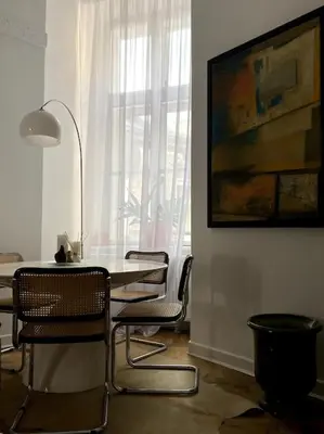 a dining room with a table and chairs and a window at In the heart of old town in Kraków
