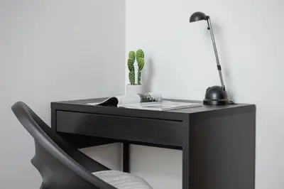 a black desk with a chair and a lamp at Cozy Apartment with Balcony Chmieleniec by Noclegi Renters in Kraków