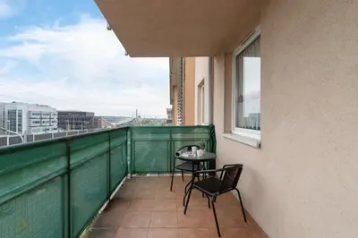 a balcony with a table and chairs on it at Cozy Apartment with Balcony Chmieleniec by Noclegi Renters in Kraków