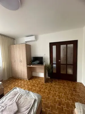 a bedroom with a bed and a wooden floor at Apartament Jaśminowa in Chrzanów