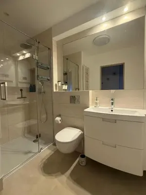 a bathroom with a toilet and a shower and a sink at Apartament Jaśminowa in Chrzanów