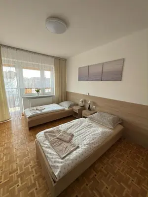 a bedroom with two beds in a room at Apartament Jaśminowa in Chrzanów