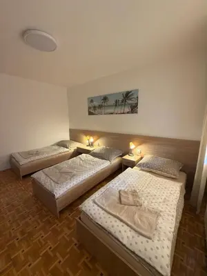 a room with three beds in a room at Apartament Jaśminowa in Chrzanów