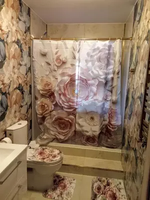 a bathroom with a shower curtain with roses on it at Flamingo in Poręba Żegoty