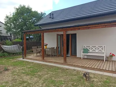 a pavilion with a bench on a deck at Piękne Zielone in Zator