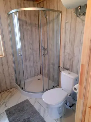 a bathroom with a shower and a toilet and a sink at Domek Na Przełęczy in Wierzbanowa