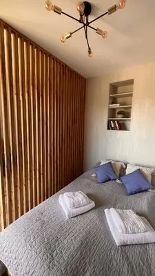 a bedroom with a bed with two pillows on it at Karmelowy Apartment in Zator