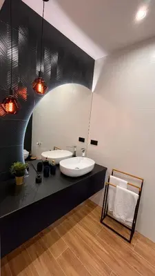 a black and white bathroom with two sinks at Karmelowy Apartment in Zator