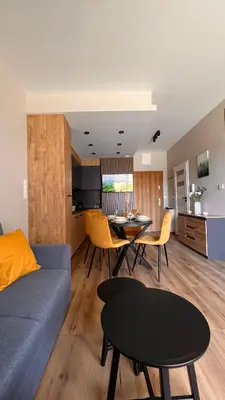 a living room with a blue couch and a table at Karmelowy Apartment in Zator