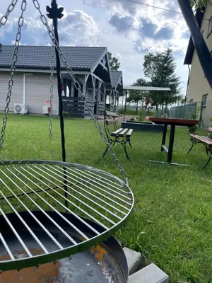 a swing in a yard with two benches and a table at Brzozowy Zakątek Zator in Zator