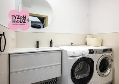 a laundry room with a washing machine and a sink at Tyzenhauz Villas in Kraków