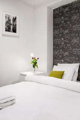 a kitchen and dining room with a table and chairs at Tyzenhauz Apartments Old Town in Kraków