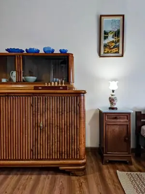 a living room with a wooden radiator and a table at Gryglówka Noclegi in Zembrzyce