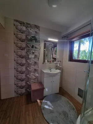 a bathroom with a sink and a mirror at Domek Nad Stawem I in Limanowa