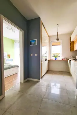 a living room with blue walls and a kitchen at Taboo by Housine in Zator