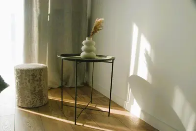 a small table with a vase on top of it at Taboo by Housine in Zator