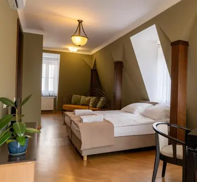 a bedroom with a bed and a chair in a room at APARTAMENT Piłsudskiego13 Chrzanów in Chrzanów