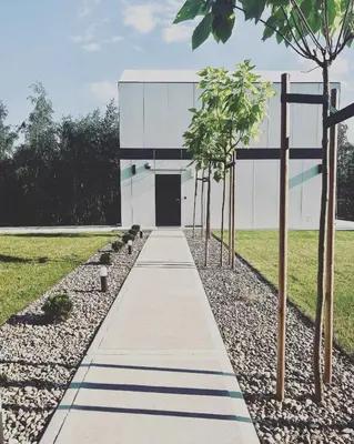 a walkway with trees in front of a building at Bukowy Las in Lipnica Górna