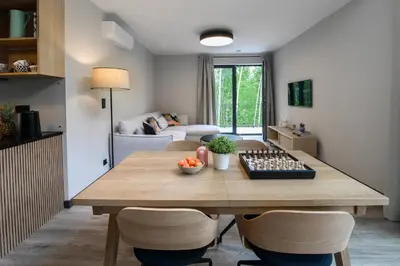 a living room with a wooden table and chairs at Bukowy Las in Lipnica Górna