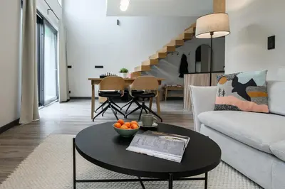 a living room with a table and a couch at Bukowy Las in Lipnica Górna