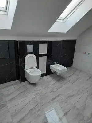 a bathroom with a toilet and a sink at Wypoczynek nad Dunajcem in Jurków