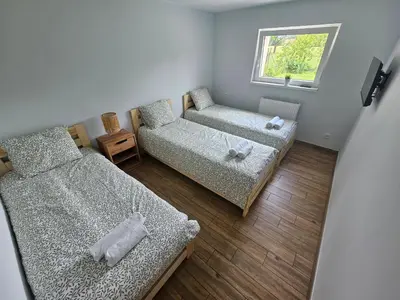 a small room with two beds and a window at Apartament Wojska Polskiego 45 in Wadowice