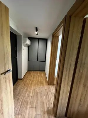 an empty room with wooden floors and a door at Apartament Wojska Polskiego 45 in Wadowice
