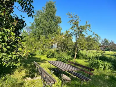 two wooden benches sitting in a field with trees at Apartament Wojska Polskiego 45 in Wadowice