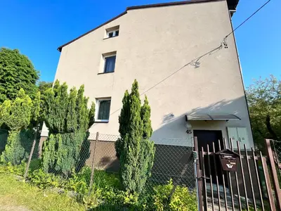 a house with a fence in front of it at Apartament Wojska Polskiego 45 in Wadowice