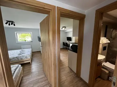 a small room with a bedroom and a bathroom at Apartament Wojska Polskiego 45 in Wadowice