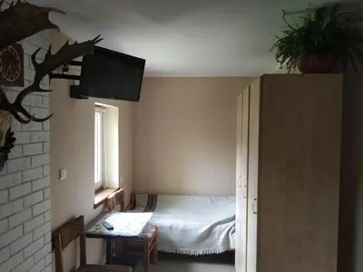 a small bedroom with a bed and a window at Domek w Bieńkówce in Bieńkówka