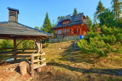 a log cabin with a gazebo and a house at Osada Pod Turbaczem in Nowy Targ