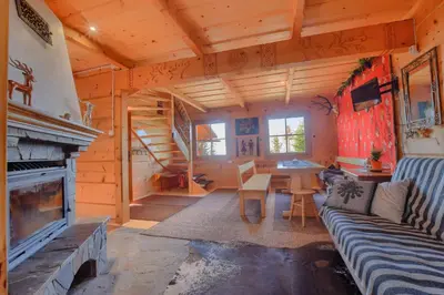 a living room with a couch and a fireplace at Osada Pod Turbaczem in Nowy Targ