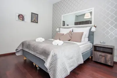 a bedroom with a bed with two towels on it at InPoint 2-bedrooms Apartment with private garden and free parking in Kraków