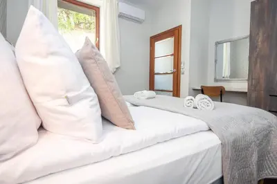 a bedroom with two beds with white pillows at InPoint 2-bedrooms Apartment with private garden and free parking in Kraków