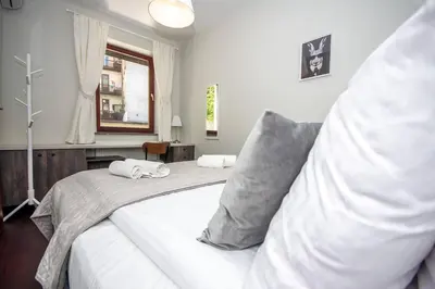 a bedroom with two beds with pillows and a window at InPoint 2-bedrooms Apartment with private garden and free parking in Kraków