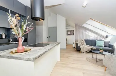 a kitchen and living room with a couch and a table at InPoint Sunny Studio next to Wawel Castle - Kossaka 5 Self Check-in in Kraków